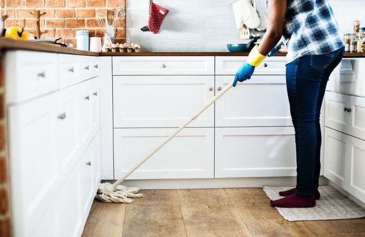 man mopping kitchen floor