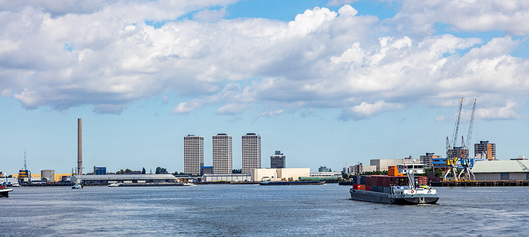 Container ship pulling into port at Rotterdam