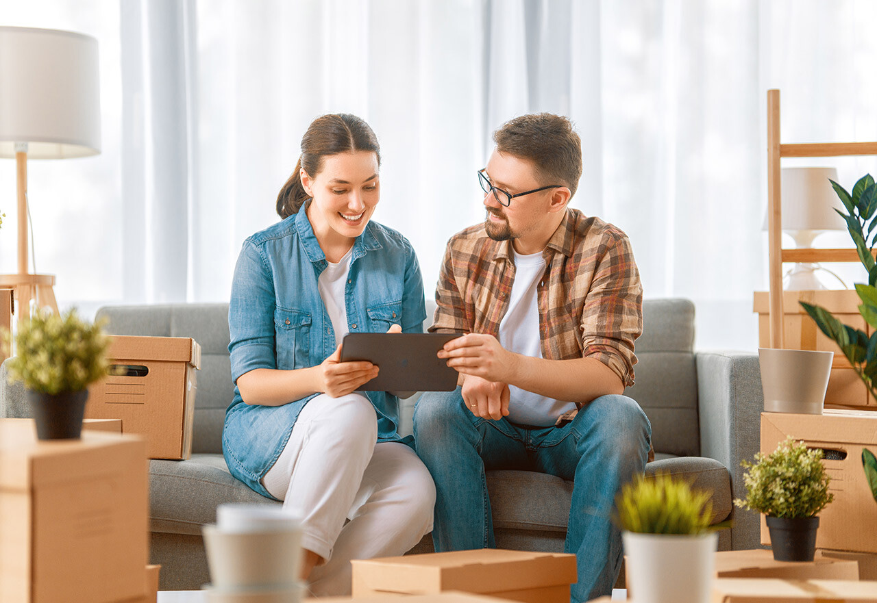 Couple creating a packing checklist for an international move