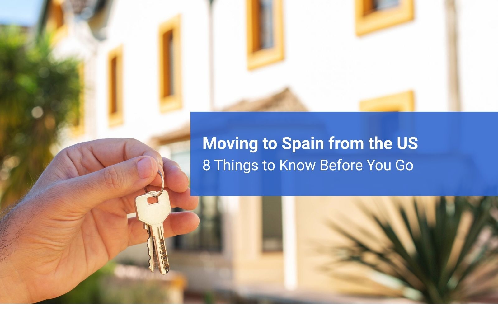 hand holding keys outside an apartment for a move from the US to Spain